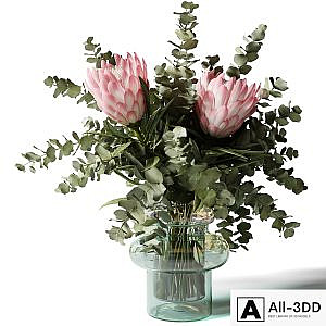 Bouquet with three pink proteas and eucalyptus in a glass vase