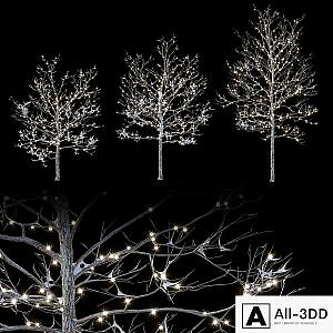 Trees in the snow with a luminous garland