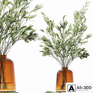 Olive stems in yellow glass vase with water
